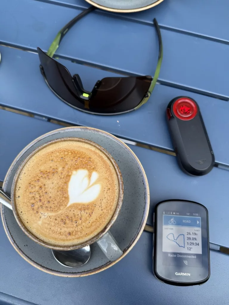 Garmin varia bike light on table with coffee and sunglasses