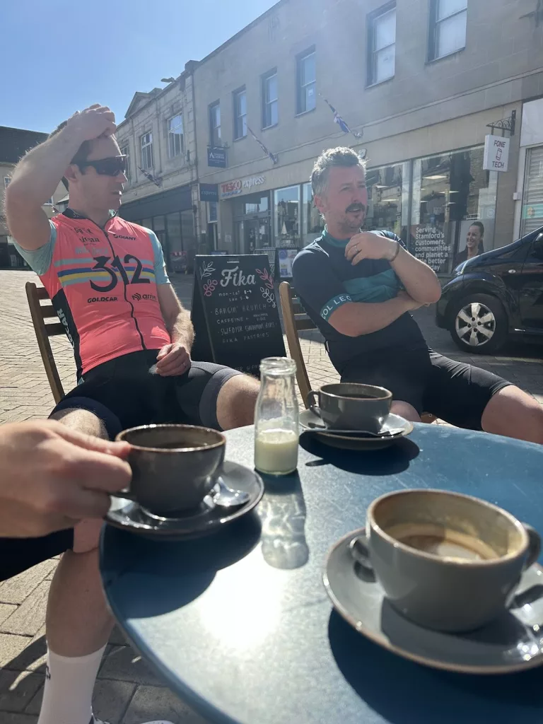Two cyclists relax outside of Fika stamford after a long bike ride