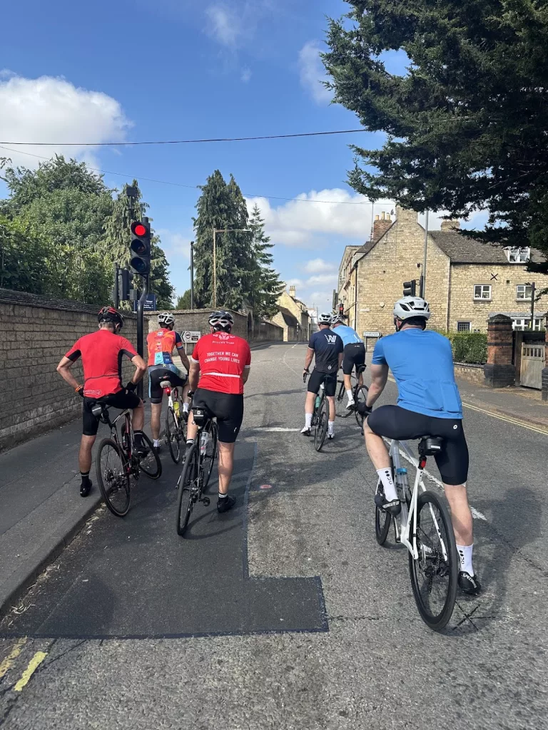 Group of stamford cyclists waiting at a traffic light