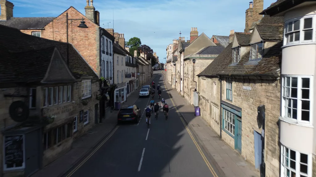 Stamford Cycling club riding out from red lion square, drone aerial image